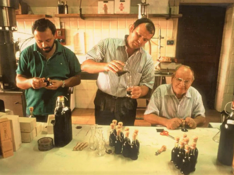 Giovanni, Roberto en Ferdinando Cavalli vullen en etiketteren flessen traditionele reggio emilia dop balsamico-azijn (ABTRE)